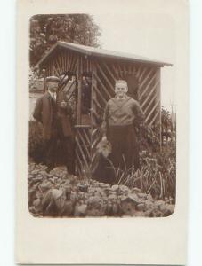 rppc 1920's COUPLE STANDING BESIDE SHELTER IN THE GARDEN AC8442