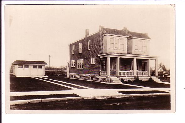 Real Photo, Brick Duplex with Garage.  1910-1930