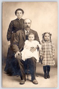 RPPC  Luello's Hard-Working Husband Holds Babe For Family Portrait~Girl w/Braids