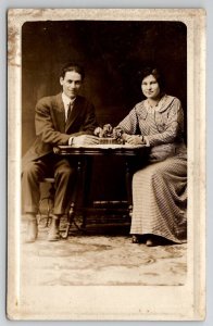 RPPC Darling Edwardian Couple Seated at Table Studio Real Photo Postcard J24