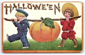 c1910 HALLOWE'EN RARE HALLOWEEN CHILDREN TOTING PUMPKIN EMBOSSED POSTCARD P3877