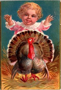 Little Girls Surprising Thanksgiving Turkey straw gold Postcard DB embossed