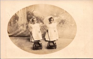 Real Photo Postcard Twin Toddlers with Toy Push Carts Early Studio Portrait 1910