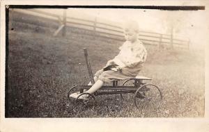 Little boy on tricycle Child, People Photo Writing on back 