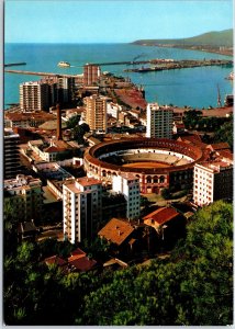 VINTAGE CONTINENTAL SIZE POSTCARD THE BULLRING AND HARBOR AT MALAGA SPAIN