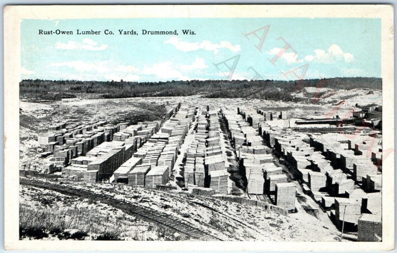 c1910s Drummond, Wis Rust-Owen Lumber Co Lumberyard Railway Postcard WI A169