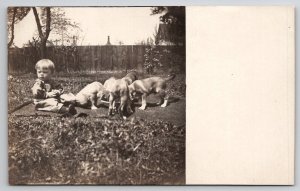 RPPC Cute Little Boy Feeding The Puppies In Yard Real Photo Postcard A49