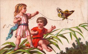 Victorian Trade Card Boy and Girl with a Butterfly L1