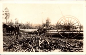 Real Photo Postcard Men Moving Logs Using Horses in a Field