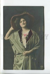 431952 Beautiful woman in a fashionable outfit and a hat Vintage tinted postcard