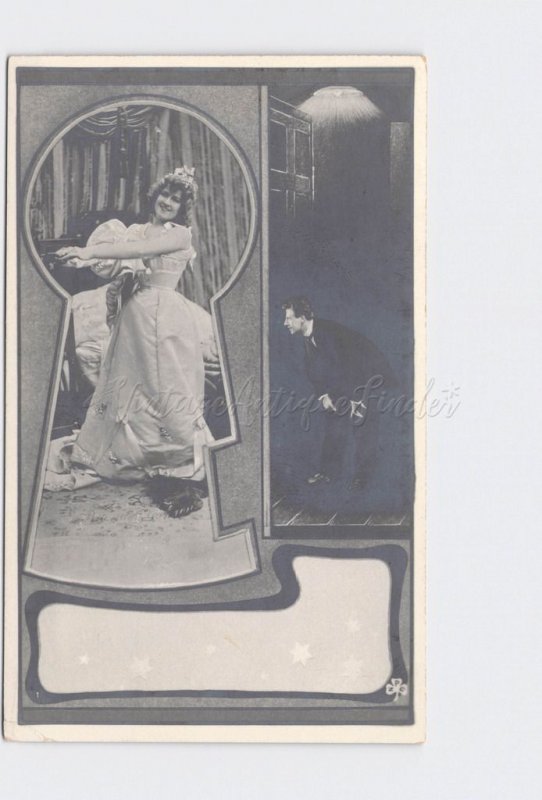 RPPC REAL PHOTO POSTCARD VOYEUR MAN PEEPING THROUGH KEYHOLE AT WOMAN AS SHE UNDR