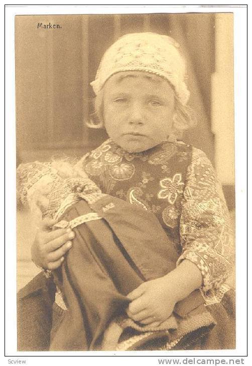 Serious blond girl from Marken holding doll, 00-10s