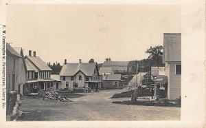 Weeks Mills ME Street View Storefronts F. W. Cunningham Wood Pile RPPC Postcard