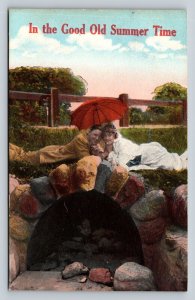 Lovers Laying in Grass Under Red Parasol By Bridge Vintage Postcard 1007