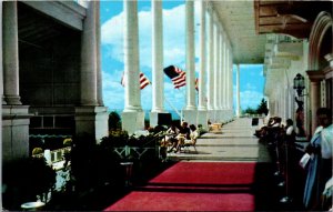 Postcard Michigan Mackinac Grand Hotel Guests on Porch American Flags 1963 V4