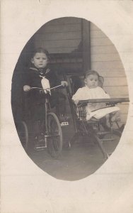 YOUNG BOY SAILOR SUIT-TRICYCLE-GIRL IN OLD HIGH CHAIR~1910s REAL PHOTO POSTCARD