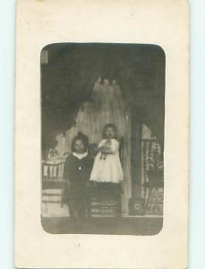 Pre-1920's rppc slightly blurred - GIRL HOLDING DOLL WITH MINI USA FLAG r6279