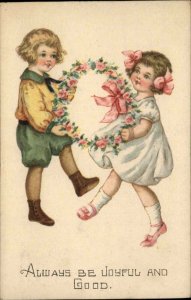 Be Joyful and Good Little Girl and Boy with Wreath Vintage Postcard