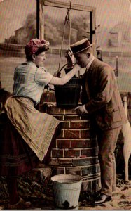 Romantic Couple Drinking From Well