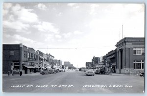 Brookings SD Postcard RPPC Photo Main St. South At 4th St. Drugs Store Cafe Cars