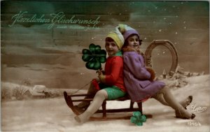 RPPC Children New Years Faux Snow Scene Clover Horseshoe Sled Postcard W11