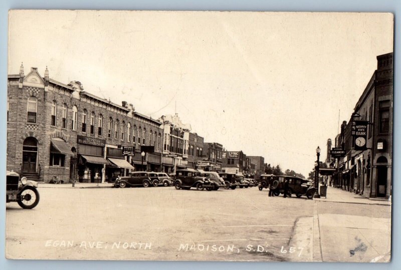 Madison South Dakota SD Postcard RPPC Photo Egan Avenue North Bank Bakery Cars