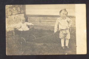 RPPC CUTE BOY PULLING TOY WAGON WITH BABY VINTAGE REAL PHOTO POSTCARD