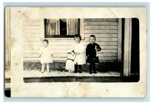 C. 1905 RPPC Cute Kids Holding Large Doll Dolls on Snowy Porch AZO Real Photo F1 