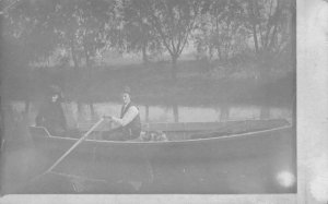 RPPC COUPLE CANOEING ON LAKE REAL PHOTO POSTCARD (c. 1910)