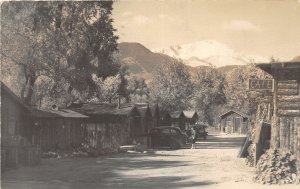 DR1/ Colorado Springs  RPPC Postcard 1940 Café Cabins Automobiles