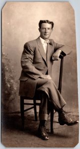 Gentleman Sitting On Chair Black Suit Tie Shoes Real Photo RPPC Postcard