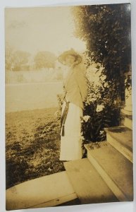 RPPC Woman in A Sweet Side Pose Near the Flowers Postcard R4