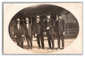 Postcard Group Of Five Men In Suits And Hats Posing In Front Of Old Store RPPC 