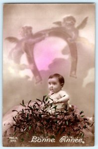 1910's RPPC HAPPY NEW YEAR BONNE ANNEE BABY ON NEST HORSESHOE ANGELS POSTCARD