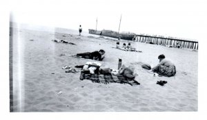 Boats anchored at a Pier People Having Picnic on Beach RPPC  Postcard