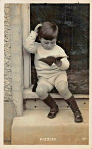 PUZZLED~YOUNG BOY READING-BRITISH PHOTO 1914 POSTCARD