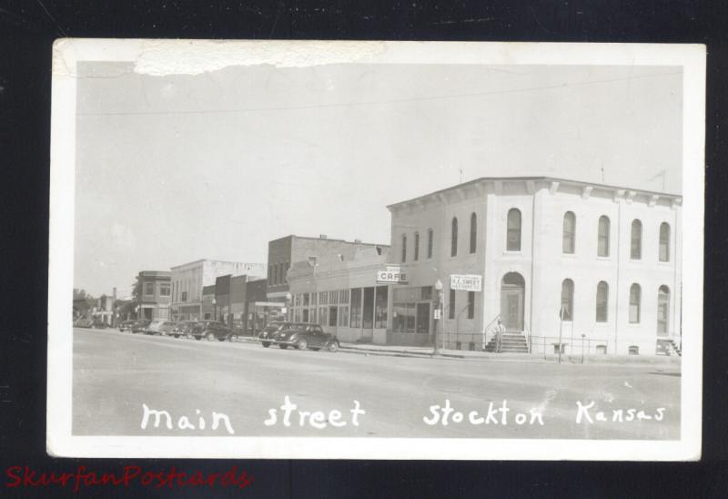 RPPC STOCKTON KANSAS DOWNTOWN MAIN STREET SCENE CARS REAL PHOTO POSTCARD