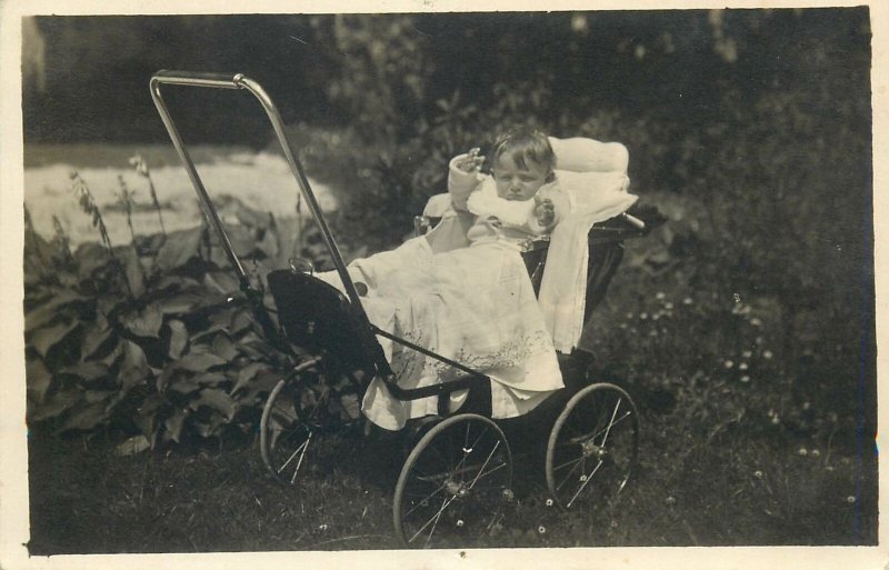 toddler in baby stroller photo Social History Postcard