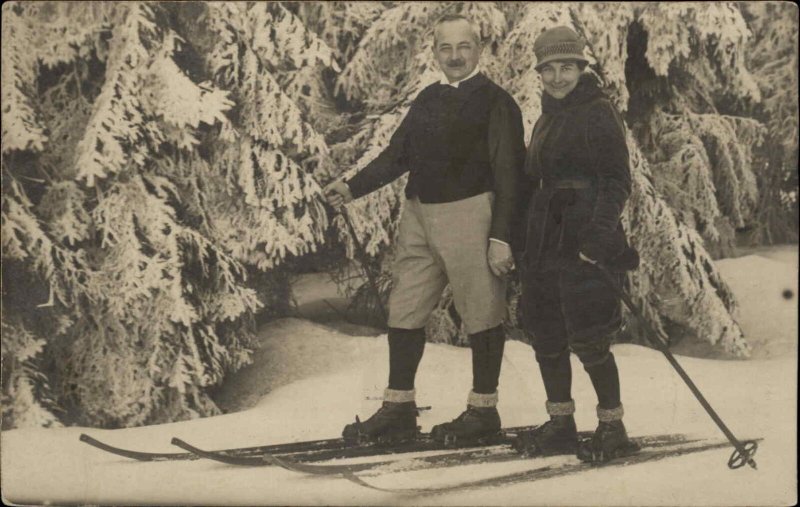 Fashionable Man and Woman Cross Country Skiing Real Photo RPPC Vintage Postcard