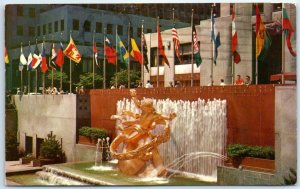 Prometheus Statue and Fountain in Rockefeller Plaza with Flags of the U. N. - NY