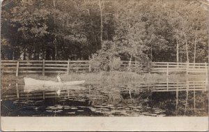 Real Photo Postcard Man in a Boat on a Lake in or near Oshkosh, Wisconsin~136611