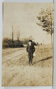 RPPC Young Boy Along Side the Road with Lunch Pail Newsboy Cap Postcard Q13