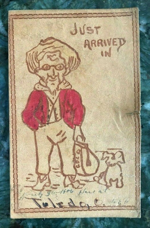 JUST ARRIVED IN TOLEDO OHIO~MAN WITH BAG OF GOLD & DOG~1900s LEATHER POSTCARD