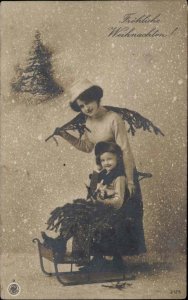 Christmas Pretty Woman Daughter in Sled Pine Boughs Studio Props c1900s-20s RPPC