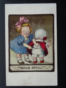 Children / Kute Kiddies TWO GIRLS CHECKING THE NAPPY - HOLD STILL c1910 Postcard