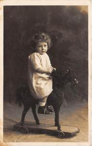 Child on toy horse Child, People Photo Unused 