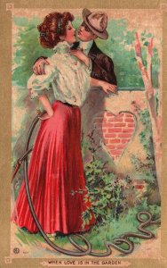 Vintage Postcard 1909 Lovers Couple In The Yard Watering The Plants Kissing