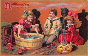 HALLOWEEN CHILDREN DUCKING FOR APPLES JOL RAPHAEL TUCK EMBOSSED POSTCARD (1908)