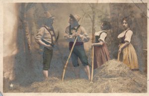 VINTAGE POSTCARD TWO MEN AND WOMEN IN HAYSTACK SCENE TINTED EARLY PHOTOTYPE