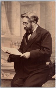 Portrait Of A Man, Sitting On Wooden Chair, Reading A Book, Vintage Postcard